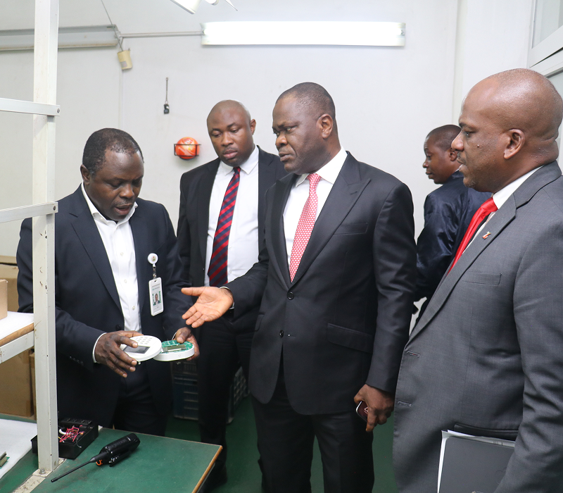 Engineer showing component to executive